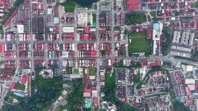 Aerial view of a red roofed city neighborhood. Green parks and a lake cut through the area at Kampar