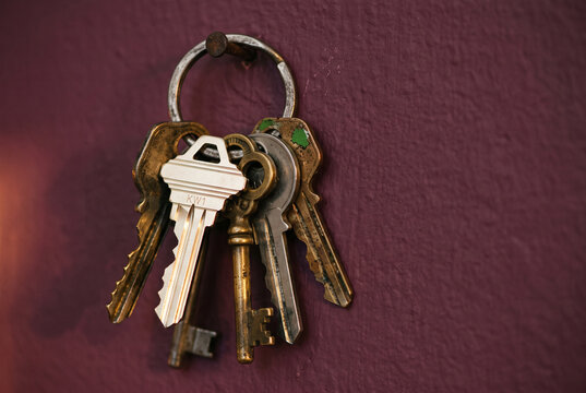 Keyring with Vintage Keys on Purple Textured Wall