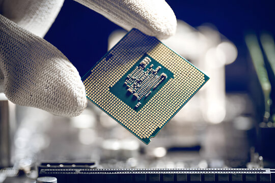 Microprocessor or CPU is held in the hand of a laboratory technician. Central Processing Unit, CPU socket of the computer motherboard, hardware technology, semiconductor chipset, Repairman computer,
