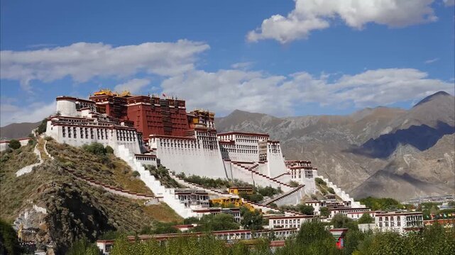Potala Palace in Lhasa, Tibet, historic Tibetan Buddhist fortress monastery on Marpo Ri hill under blue sky with scattered clouds