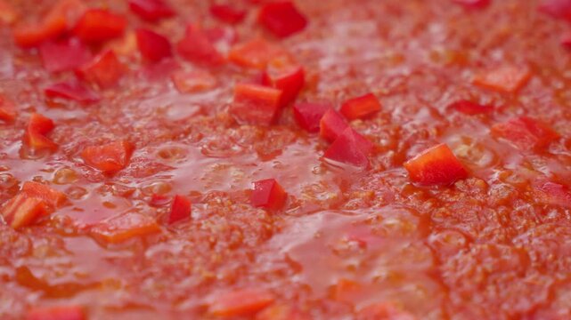 Delicious spanish paella cooking with fresh red pepper