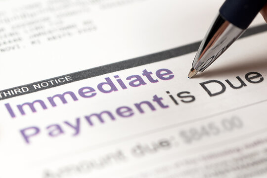 Medical billing statement showing immediate payment is due, with a pen. Highlights financial stress, healthcare costs, debt, and overdue payments.