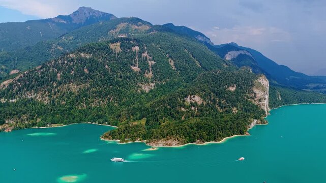 Wolfgangsee Lake in Austria, 4k. Scenic nature view over Wolfgangsee lake. Wolfgangsee lake with mountain landscape. Landscape of mountain peak and Wolfgangsee lake. Nature landscape