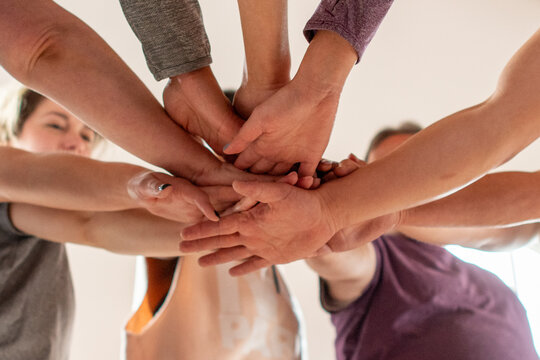 Team unity through joined hands.