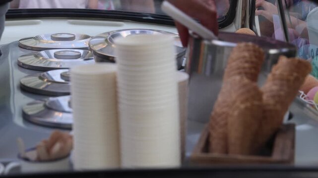 Ice cream seller replacing empty canisters, close up