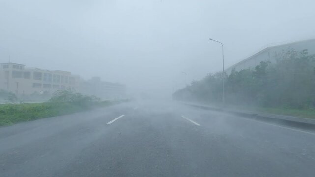 Powerful Hurricane Winds Drive Sheets Of Rain Across City Highway