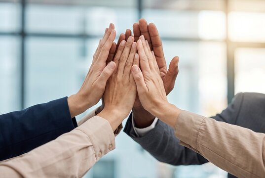 Diverse Team Joining Hands to Celebrate Collective Success