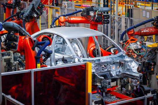 Automotive industry robotic arm assembly line
