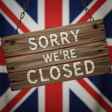 A wooden sign saying sorry we're closed in front of a uk flag illustration