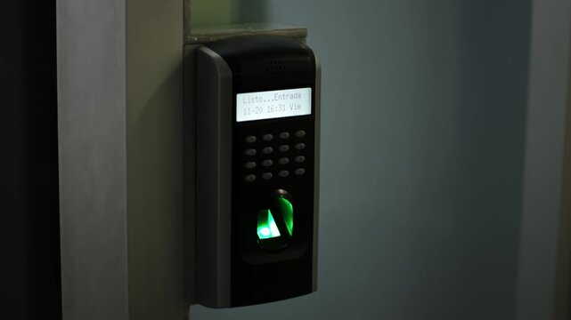Close up of a modern biometric fingerprint scanner machine used for employee time attendance and secure office access control