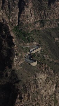Elevated drone view showing a car navigating the dangerous. Winding roads carved into the steep. Rocky mountainsides of taiz. Yemen. In taiz yemen