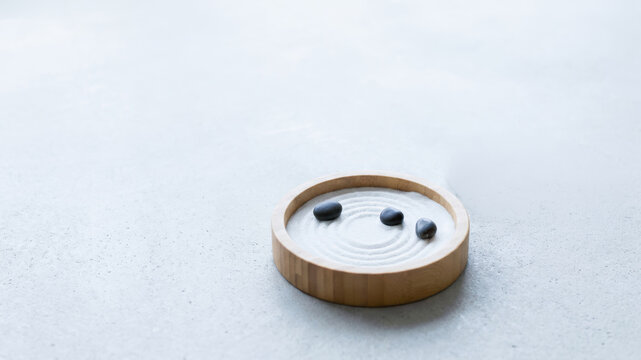 Bamboo bowl with white cream and blueberries creating calm minimalist food scene on pale surface