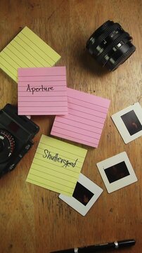 Video of hand with notes about Exposure Triangle in photography Shutter Speed, Aperture and ISO