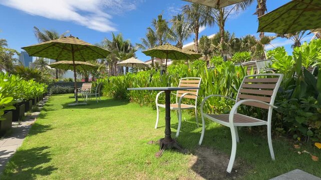 Cozy Tropical Garden Lounge with Umbrellas and wooden Chairs