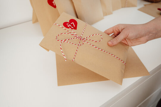 woman packing advent calendar craft bags for christmas. winter holidays traditions
