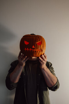 spooky halloween banner with man holding jack or lantern instead of his head, vertical banner