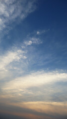 Obraz premium Vertical Blue Sky with Golden Sunset Clouds Full Frame Background