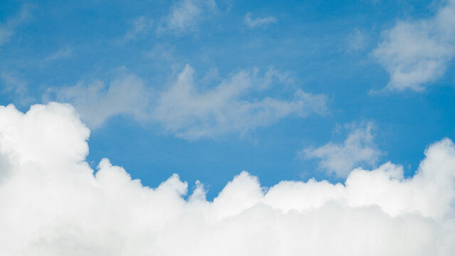 The photo shows a blue sky and clouds