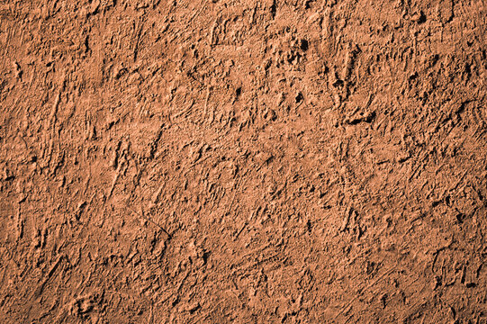 Brown background, photo of the texture of an old wall with various lines, embossing, and brushstrokes