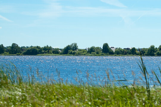 A summer landscape featuring a river with its banks and a blue sky