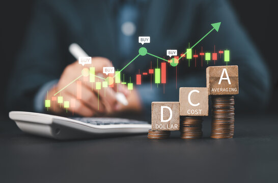 DCA word on a wooden cube on coins in idea Dollar Cost Averaging investment strategy, Saving stock or savings on a monthly, quarterly basis.