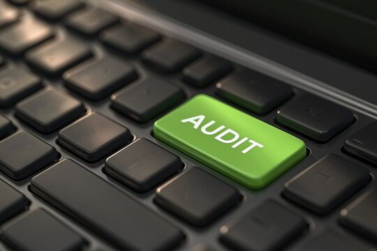 Close up green audit key on black computer
