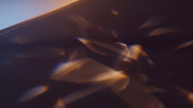 Abstract light refraction texture with soft golden lens flare effects