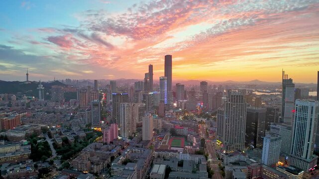 Modern city skyline with the dramatic sky at sunset, Dalian, China.