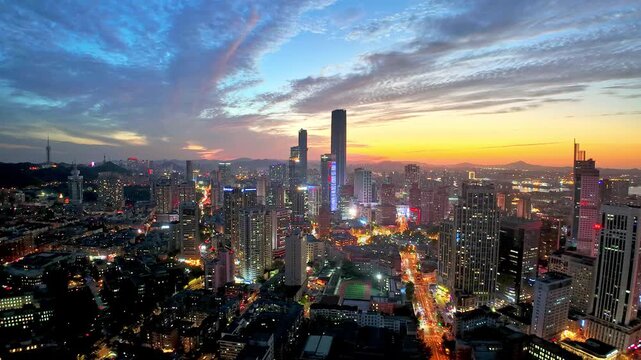 Modern city skyline with the dramatic sky at dusk, Dalian, China.