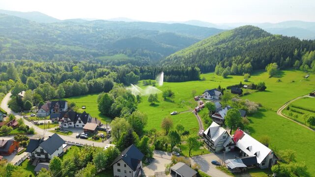 Aerial View of Firefighting Training Exercise with Multiple Fire Trucks in the Forest