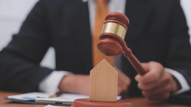 Building blueprint with judge gavel and helmet symbolizing construction law