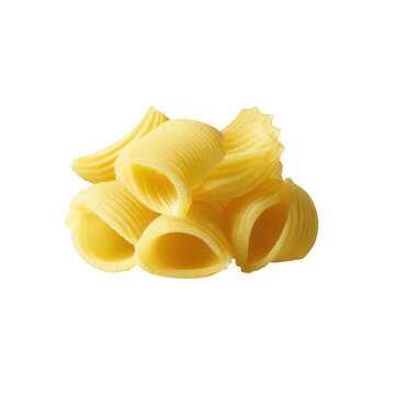 Fresh yellow pasta shells arranged in a natural pile with bright lighting