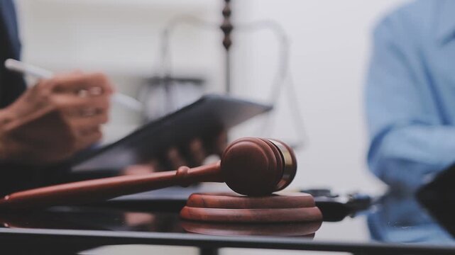 Building blueprint with judge gavel and helmet symbolizing construction law