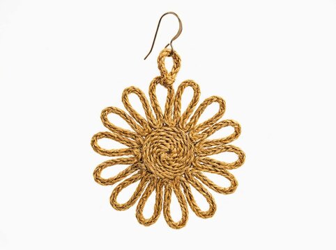 Handmade woven straw earring, bohemian flower jewelry accessory, natural fiber sunburst pendant on white background