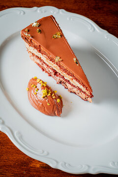Indulging in a decadent chocolate layer cake with rich mousse on a white platter