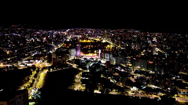 Night Aerial View of Quito Ecuador City Lights, Illuminated Streets, High Rise Buildings and Mountain Capital Urban Landscape