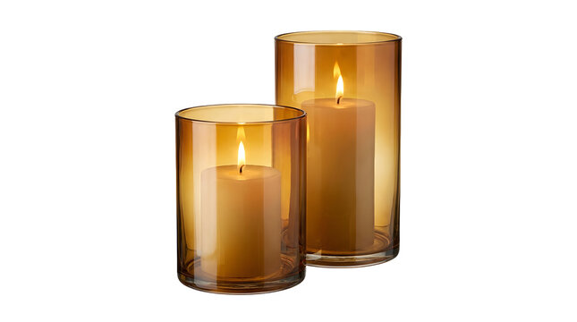 Two lit pillar candles in amber glass holders isolated on a white background for home decor design