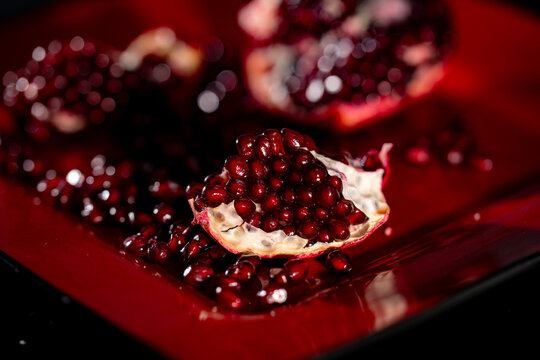 Fresh pomegranate. Red ruby pomegranate arils. Pomegranate seeds. Pomegranate garnet fruit.