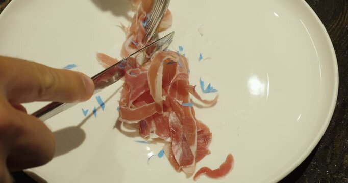 Cutting food contaminated with microplastic particles on a plate.