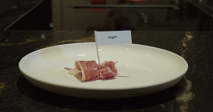Vegan label placed on meat as a food concept.