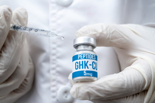 Doctor in Gloves Holding Insulin Syringe with Droplet and GHK-CU Peptide Vial