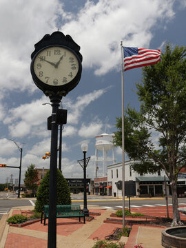 Henderson TX - June 28, 2026: Historic Clock and Flag Located in Downtown Henderson TX