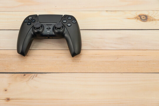Bogota, Colombia - August 2026 Black ps5 dualsense controller on wooden table