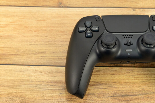 Bogota, Colombia - August 2026 Black ps5 dualsense controller on wooden table