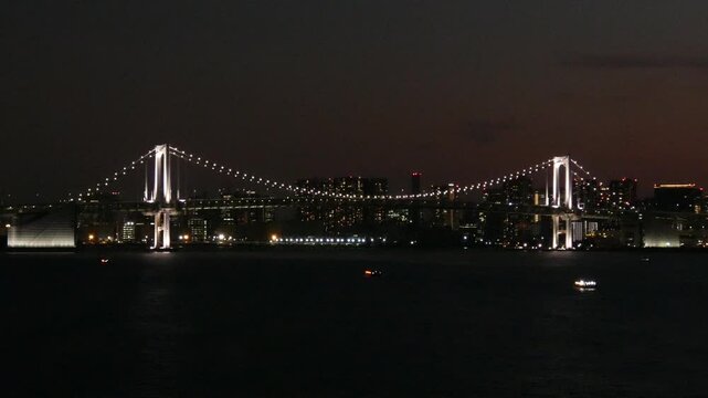 (Night view) Static long-shot footage of the Rainbow Bridge in Minato City, Tokyo.