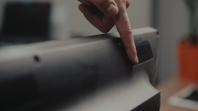 Close-up hand of unrecognizable person running finger over dusty computer monitor, concept of need for regular cleaning, maintenance, workplace hygiene. Shooting in slow motion.