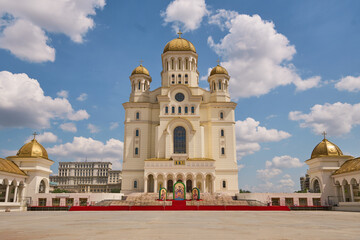 Front view of the majestic People's Salvation Cathedral with its golden domes under a blue sky in Bucharest, Romania. © Antotry