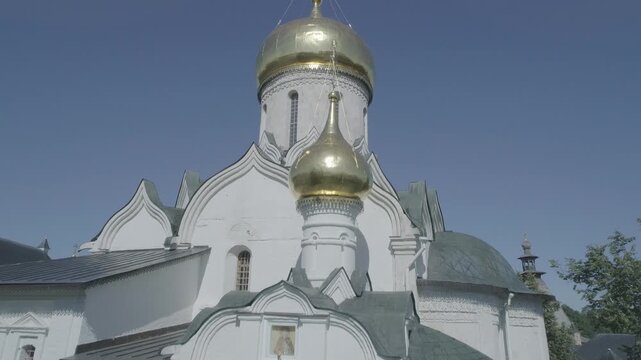 Drone lifts toward golden church domes in Zvenigorod