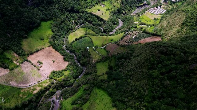 Drone View of River Valley and Patchwork Farms in Ecuador Mountains, Green Slopes, Forest Edge and Scenic Rural Andean Landscape