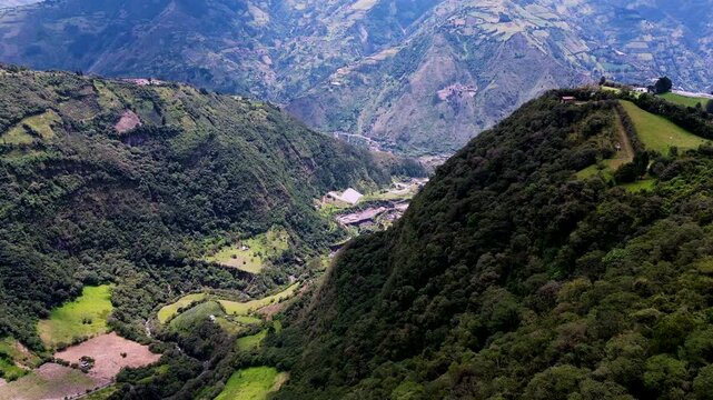 Aerial View of Deep Andean Valley in Ecuador with River, Green Mountain Slopes, Farmland and Remote Scenic Highland Travel Landscape
